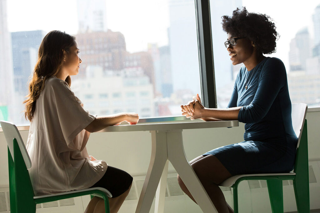 Two people at a table talking